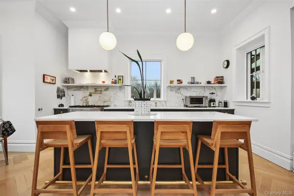 a kitchen with a sink and chairs