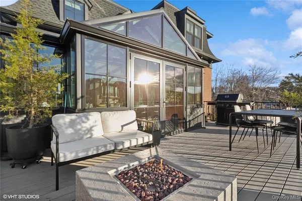 a view of a patio with couches table and chairs and potted plants