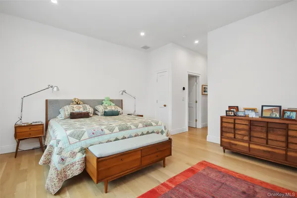 a spacious bedroom with a bed and a couch