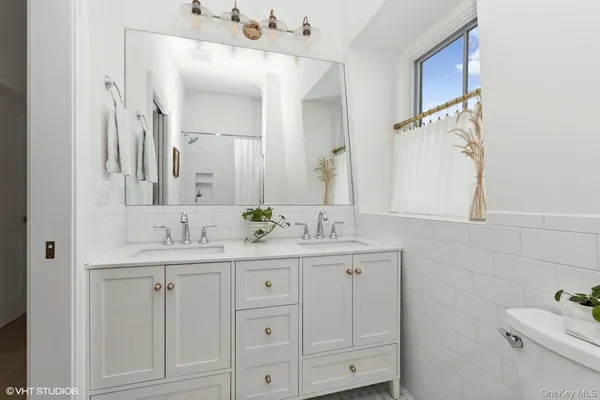 a bathroom with a sink vanity granite and a mirror