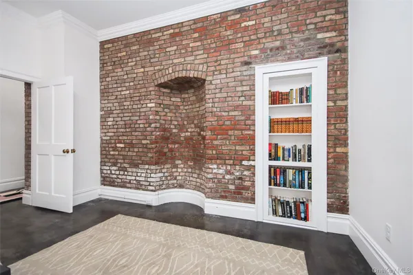 a view of empty room with wooden floor and cabinet