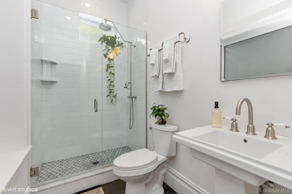 a bathroom with a sink toilet and shower