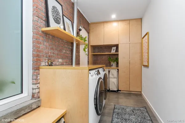 a view of a storage & utility room with a washer dryer