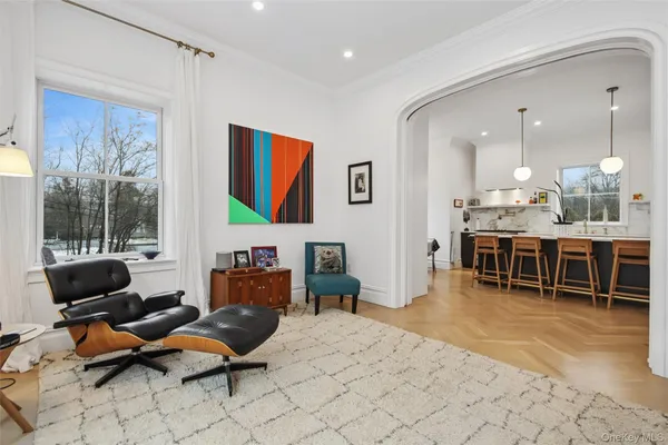 a living room with furniture a dining table and kitchen view