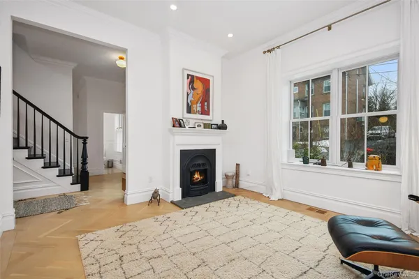 a view of a livingroom with a fireplace and workspace