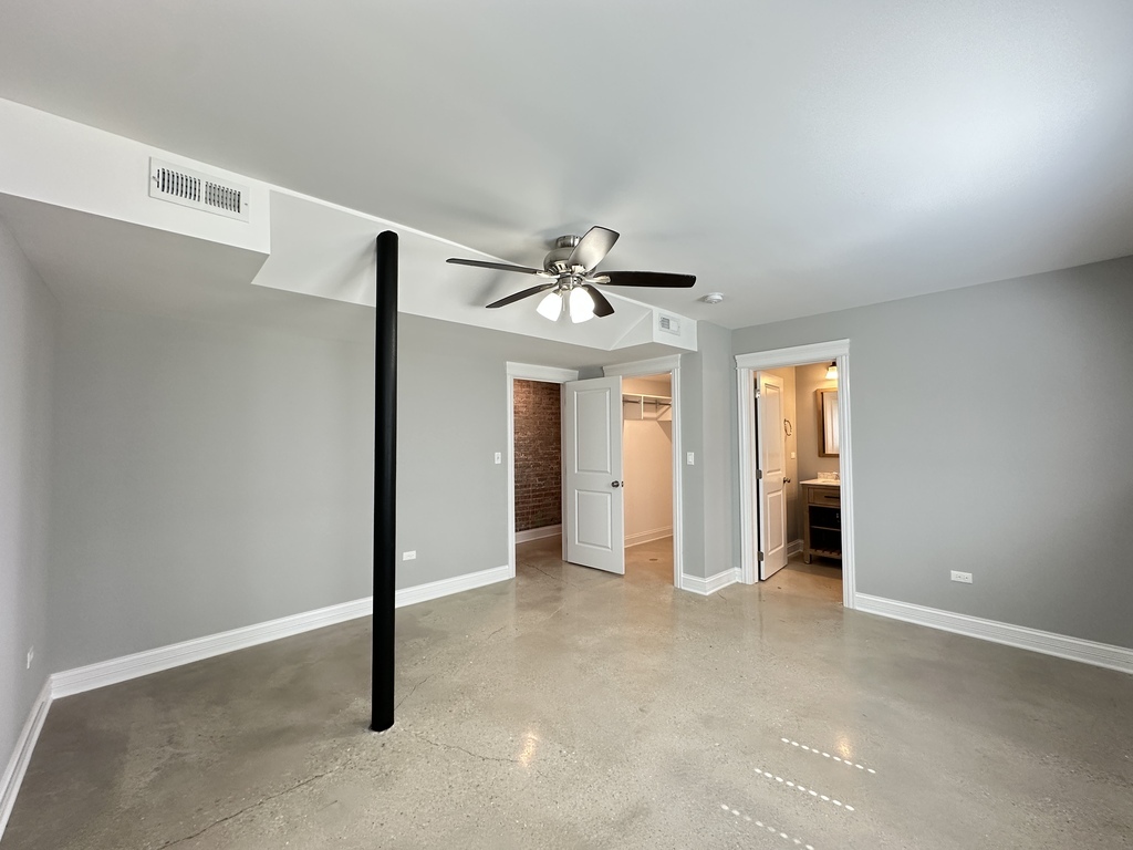 4117 South Michigan Avenue, Unit GS Chicago, IL 60653 - Photo 17 of 20 an empty room with closet and a ceiling fan