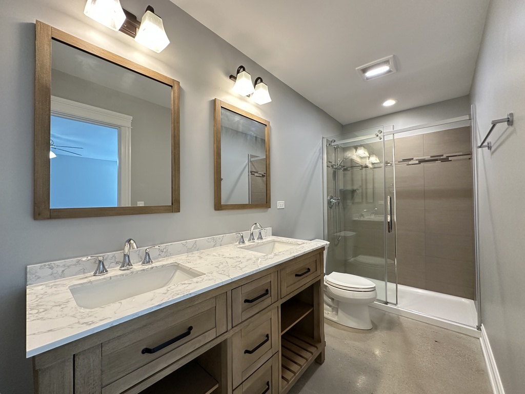 4117 South Michigan Avenue, Unit GS Chicago, IL 60653 - Photo 18 of 20 a bathroom with a double vanity sink mirror double and toilet