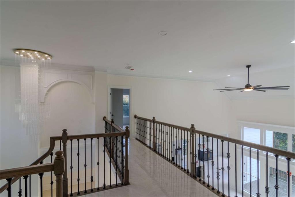 4822 Chamblee Dunwoody Road Atlanta, GA 30338 - Photo 12 of 65 a view of staircase with railing and a chandelier