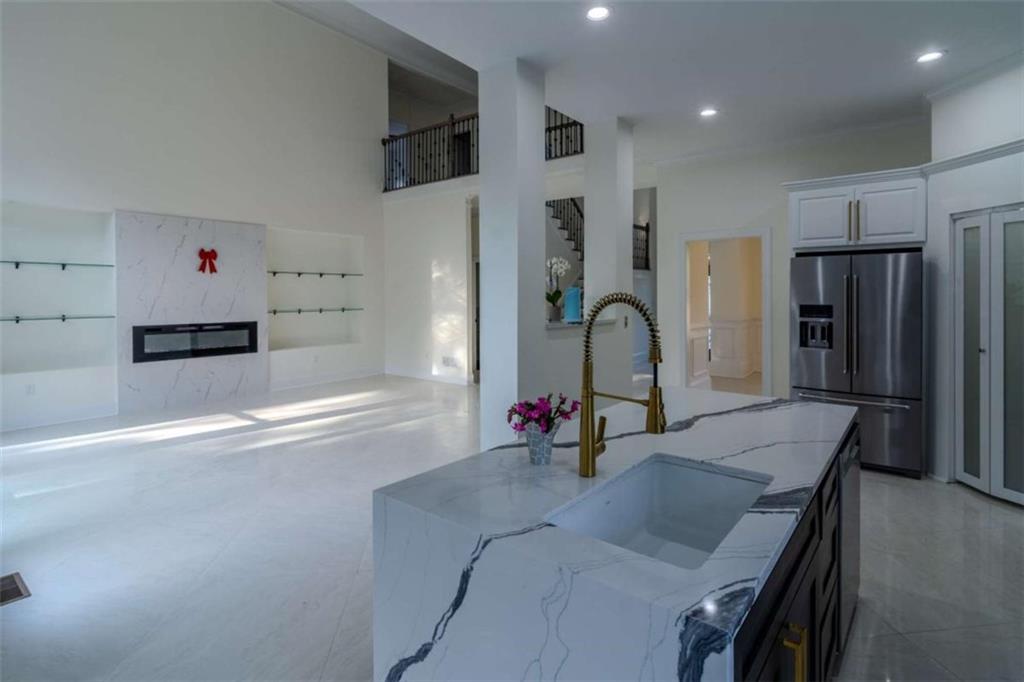 4822 Chamblee Dunwoody Road Atlanta, GA 30338 - Photo 22 of 65 a kitchen with stainless steel appliances granite countertop a sink and a refrigerator
