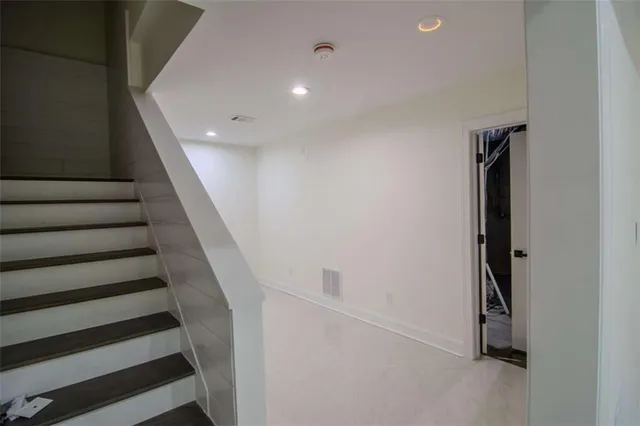 a white toilet sitting next to a shower