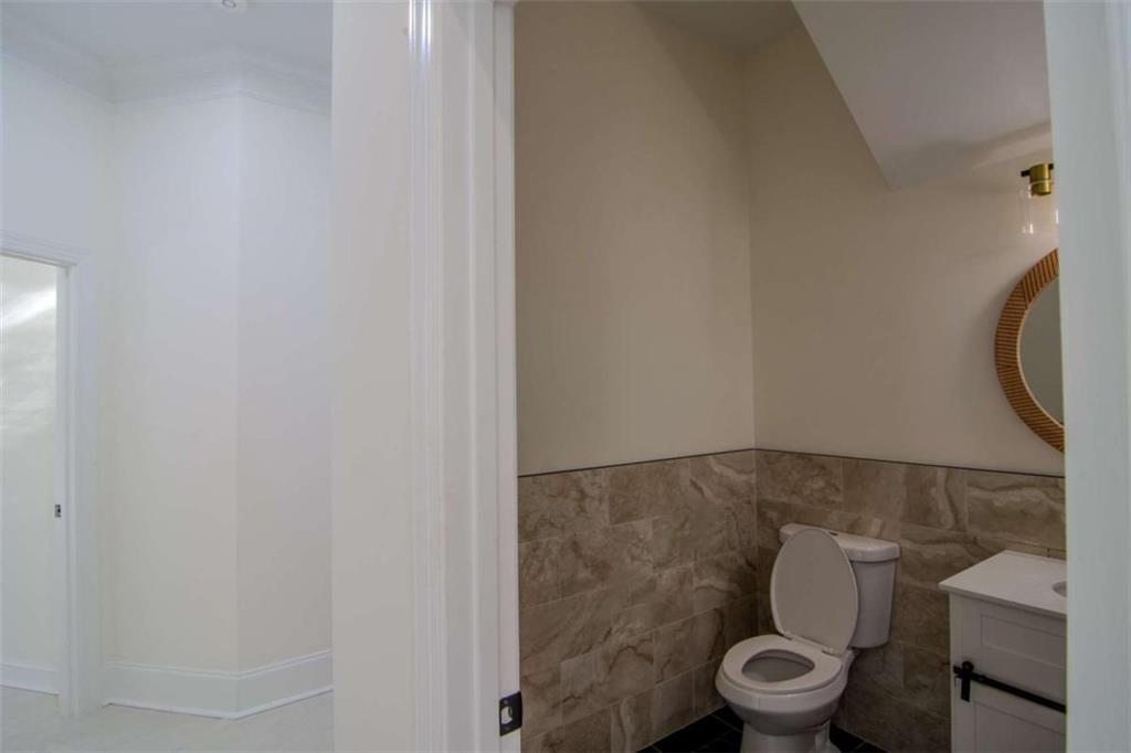 4822 Chamblee Dunwoody Road Atlanta, GA 30338 - Photo 36 of 65 a white toilet sitting next to a shower