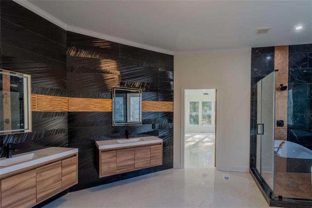 4822 Chamblee Dunwoody Road Atlanta, GA 30338 - Photo 41 of 65 a bathroom with a double vanity sink and mirror