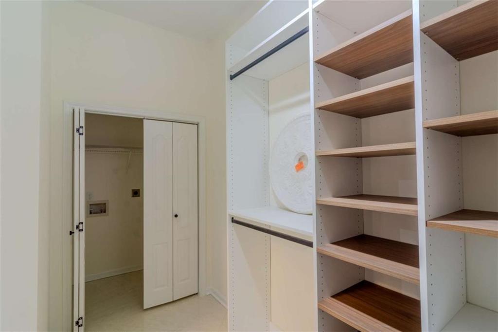 4822 Chamblee Dunwoody Road Atlanta, GA 30338 - Photo 43 of 65 a view of walk in closet with empty racks