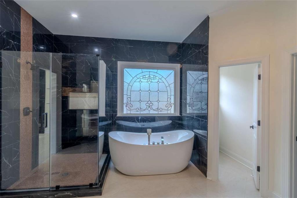 4822 Chamblee Dunwoody Road Atlanta, GA 30338 - Photo 44 of 65 a bathroom with bathtub and window