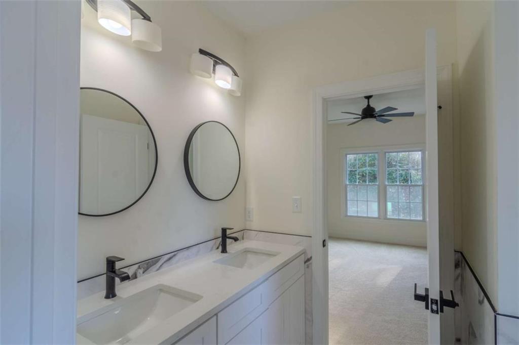 4822 Chamblee Dunwoody Road Atlanta, GA 30338 - Photo 46 of 65 a bathroom with a sink and a mirror