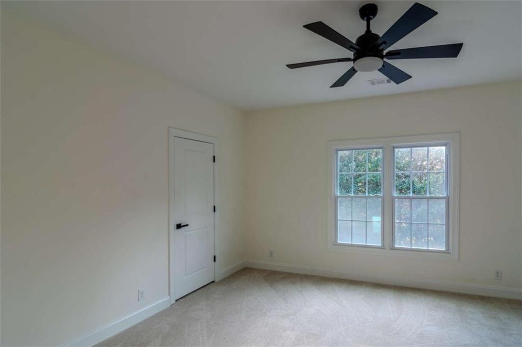 4822 Chamblee Dunwoody Road Atlanta, GA 30338 - Photo 49 of 65 an empty room with a window and a fan