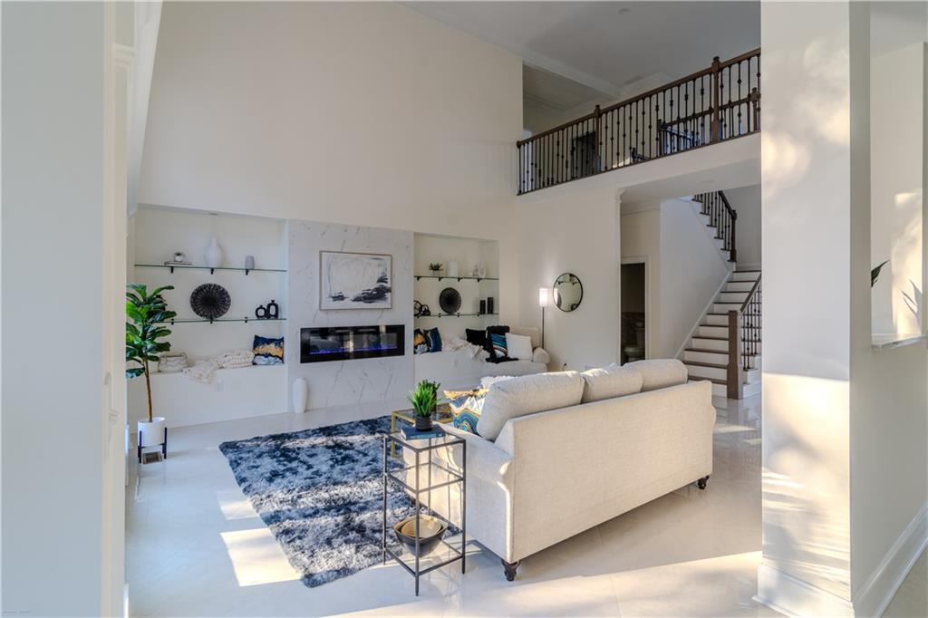 4822 Chamblee Dunwoody Road Atlanta, GA 30338 - Photo 57 of 65 a living room with furniture and a fireplace