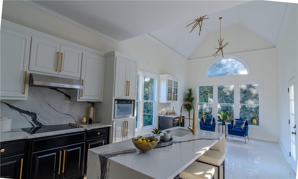 4822 Chamblee Dunwoody Road Atlanta, GA 30338 - Photo 59 of 65 a kitchen with stainless steel appliances granite countertop a stove a refrigerator a sink dishwasher a dining table and chairs with wooden floor