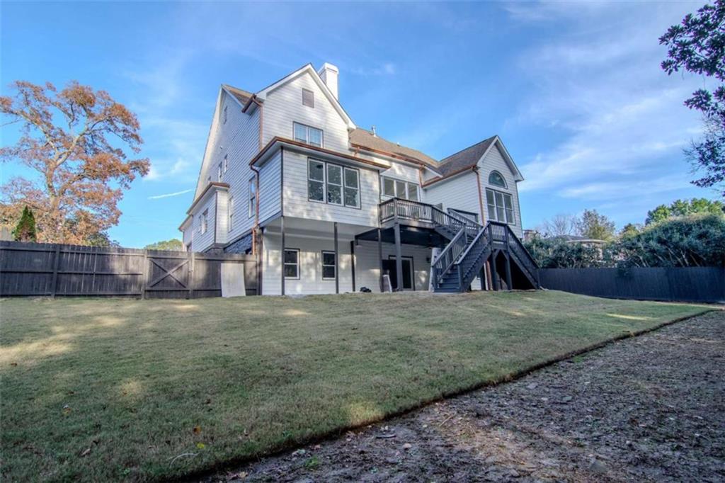 4822 Chamblee Dunwoody Road Atlanta, GA 30338 - Photo 6 of 65 a view of a big house with wooden fence