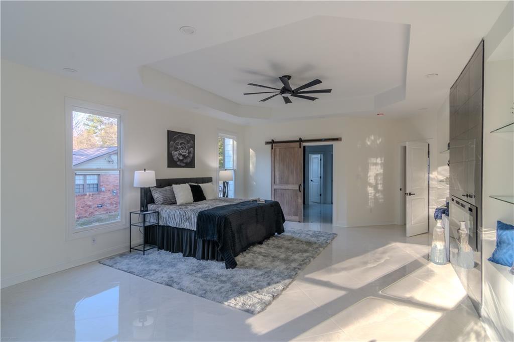 4822 Chamblee Dunwoody Road Atlanta, GA 30338 - Photo 61 of 65 a living room with furniture and a flat screen tv