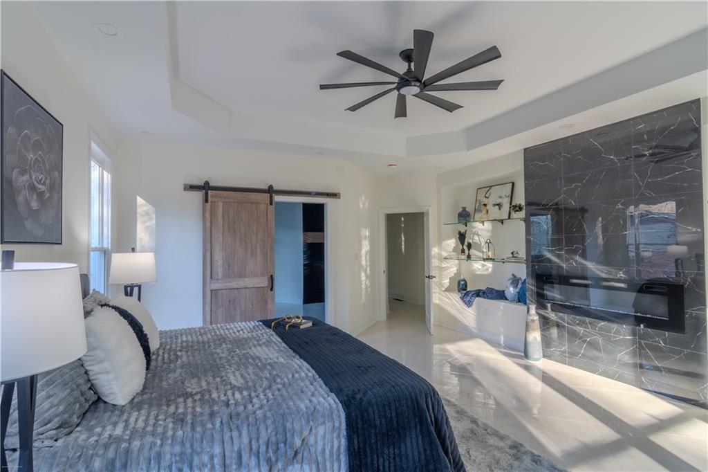 4822 Chamblee Dunwoody Road Atlanta, GA 30338 - Photo 62 of 65 a bedroom with a bed mirror and a view of living room