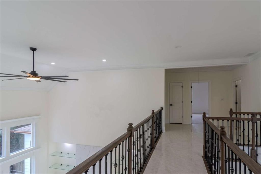 4822 Chamblee Dunwoody Road Atlanta, GA 30338 - Photo 9 of 65 a view of a hallway with wooden floor and staircase