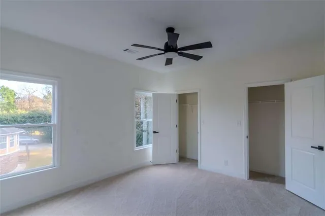 a view of a livingroom with a ceiling fan and window