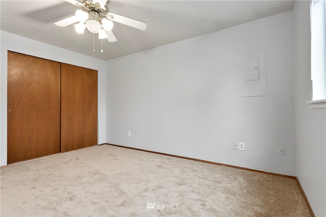 8620 Bender Road Lynden, WA 98264 - Photo 14 of 37 an empty room with a chandelier fan and windows