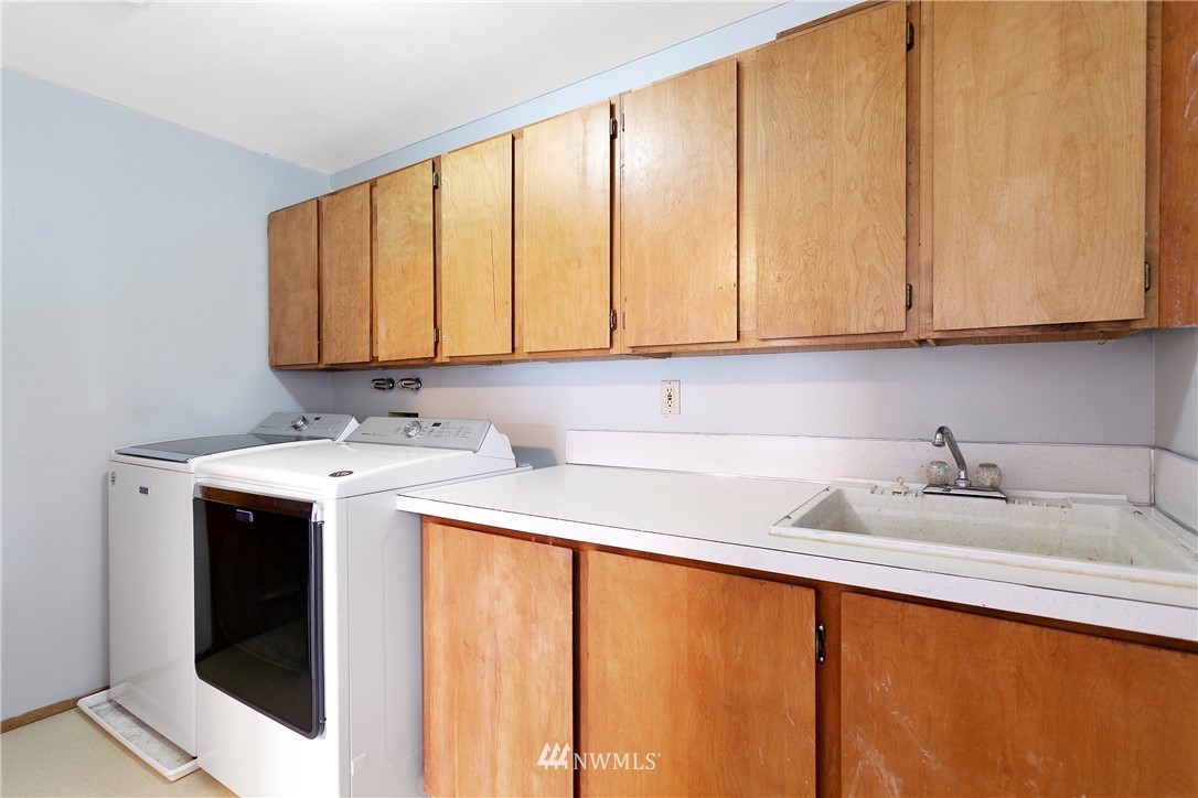 8620 Bender Road Lynden, WA 98264 - Photo 19 of 37 a utility room with stainless steel appliances granite countertop a sink and cabinets