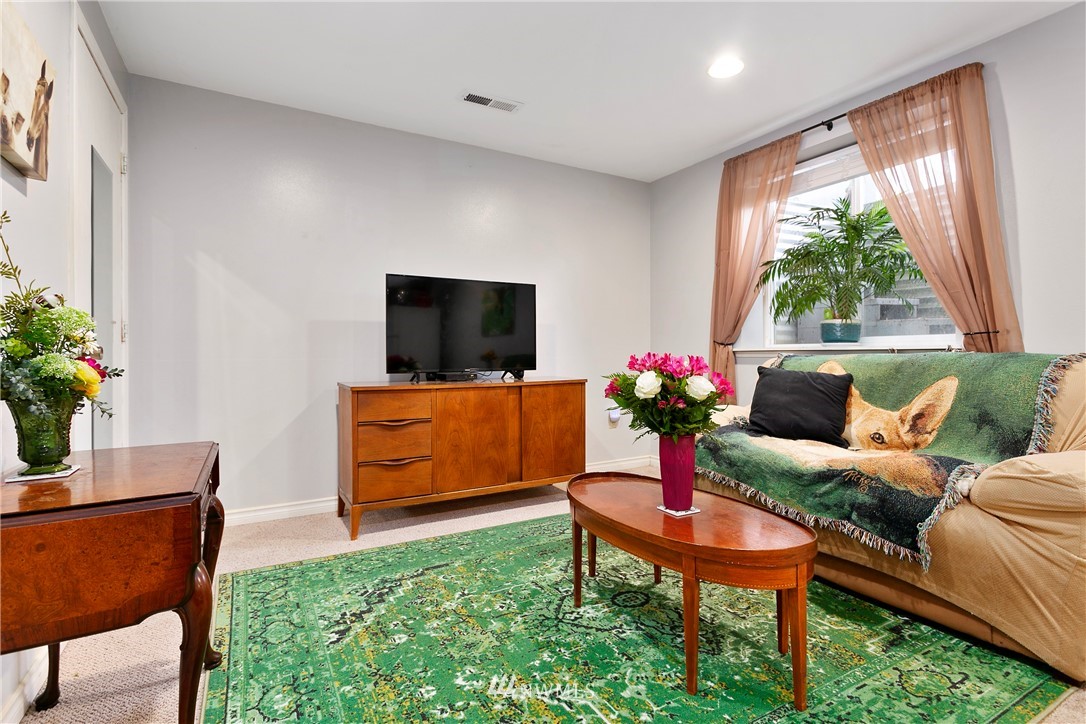 8620 Bender Road Lynden, WA 98264 - Photo 24 of 37 a living room with furniture a window and a flat screen tv