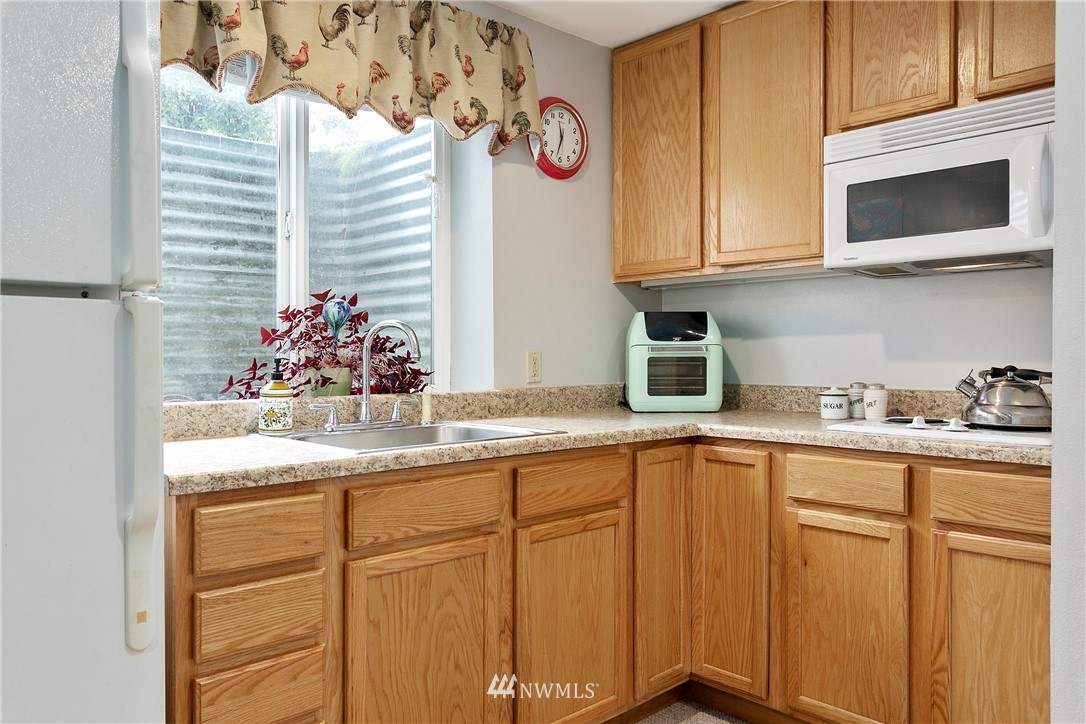 8620 Bender Road Lynden, WA 98264 - Photo 27 of 37 a kitchen with stainless steel appliances granite countertop a sink and cabinets with wooden floor