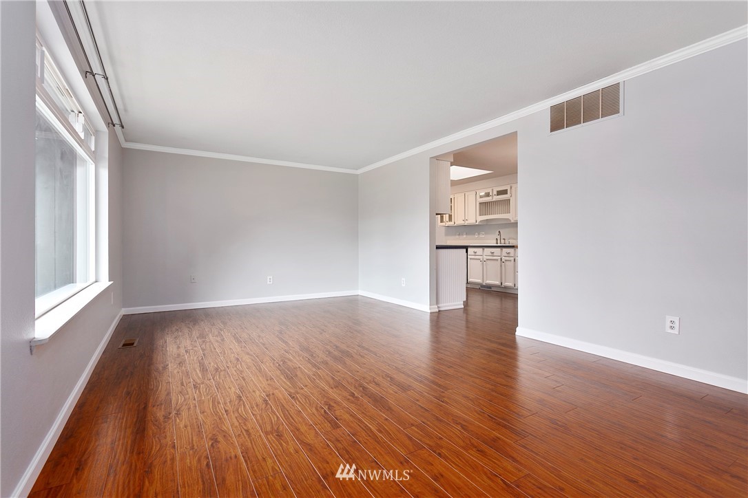 8620 Bender Road Lynden, WA 98264 - Photo 4 of 37 a view of empty room with wooden floor and kitchen