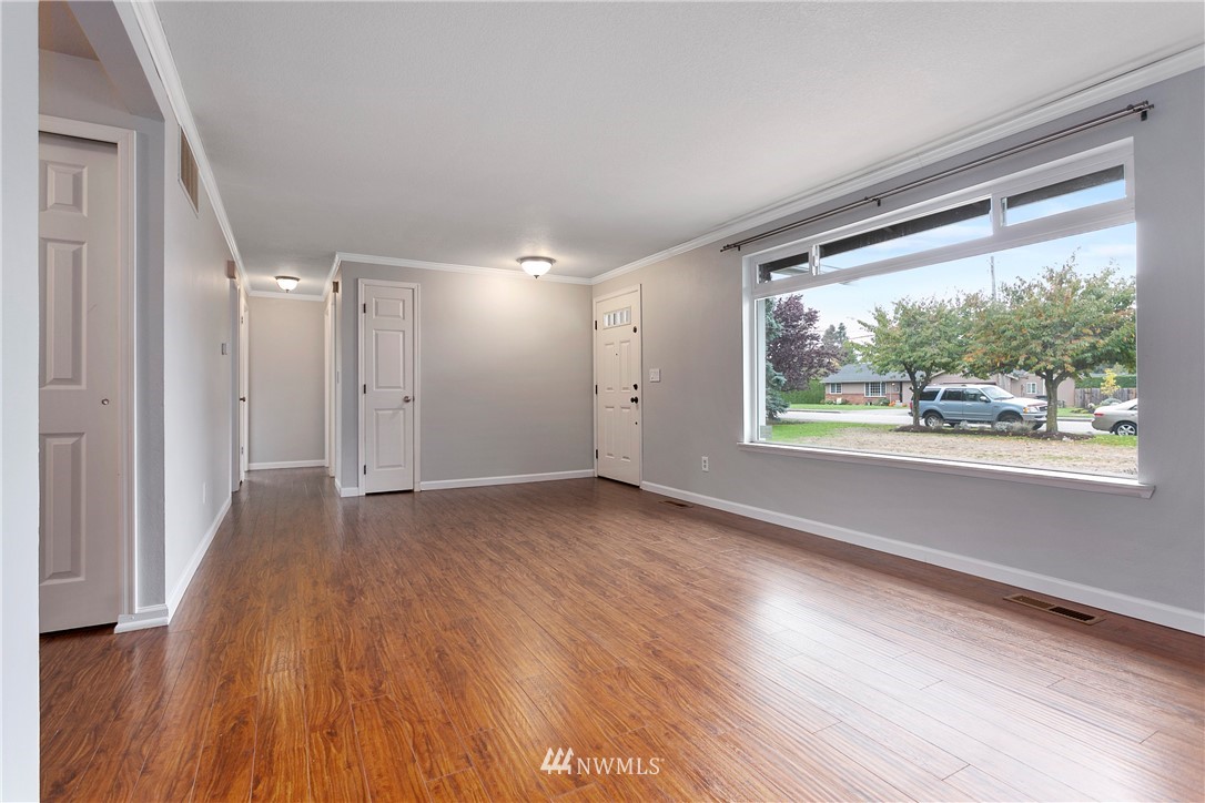 8620 Bender Road Lynden, WA 98264 - Photo 5 of 37 a view of an empty room with wooden floor and a window