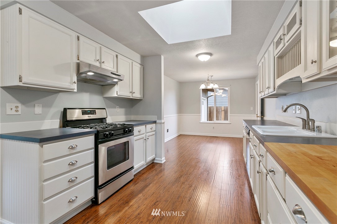 8620 Bender Road Lynden, WA 98264 - Photo 7 of 37 a kitchen with stainless steel appliances granite countertop a sink stove and cabinets