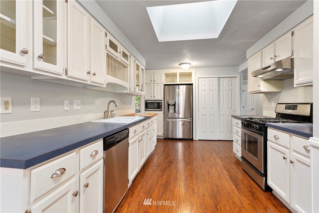 8620 Bender Road Lynden, WA 98264 - Photo 8 of 37 a kitchen with stainless steel appliances a sink dishwasher stove and refrigerator