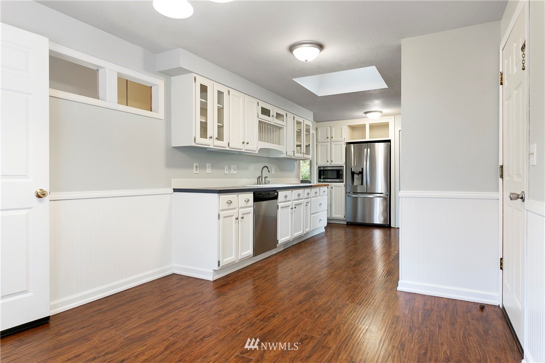 8620 Bender Road Lynden, WA 98264 - Photo 9 of 37 a kitchen with stainless steel appliances granite countertop a refrigerator and a stove top oven