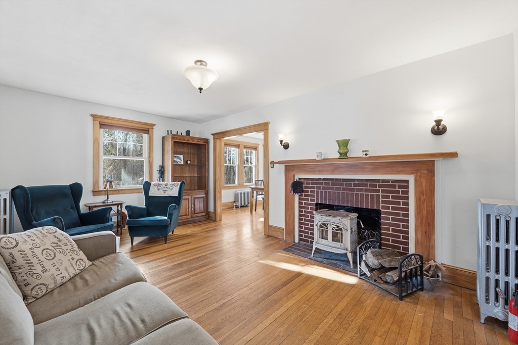 21 High Street Pepperell, MA 01463 - Photo 11 of 40 a living room with furniture and a fireplace