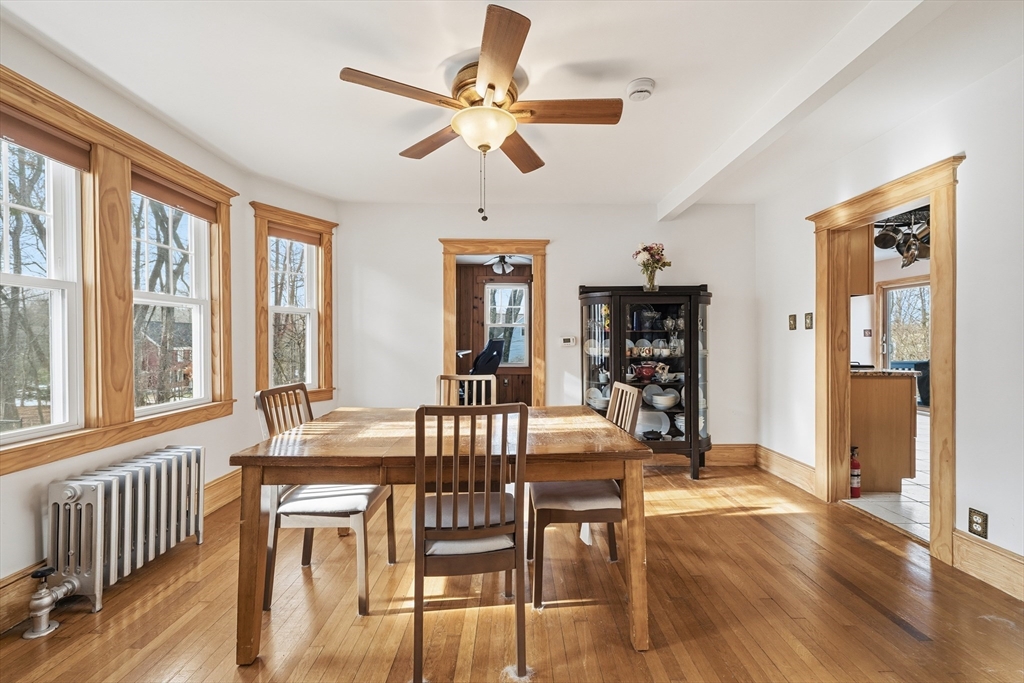 21 High Street Pepperell, MA 01463 - Photo 13 of 40 a dining room with wooden floor a chandelier fan a wooden table and chairs