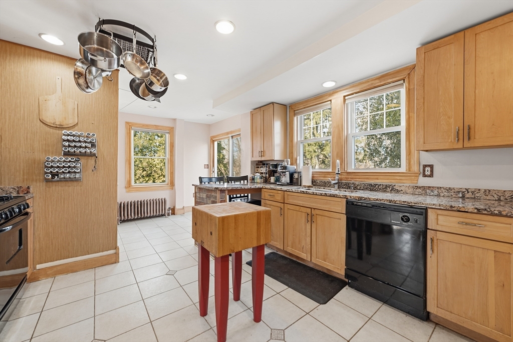 21 High Street Pepperell, MA 01463 - Photo 17 of 40 a kitchen with a sink a stove a dining table and chairs
