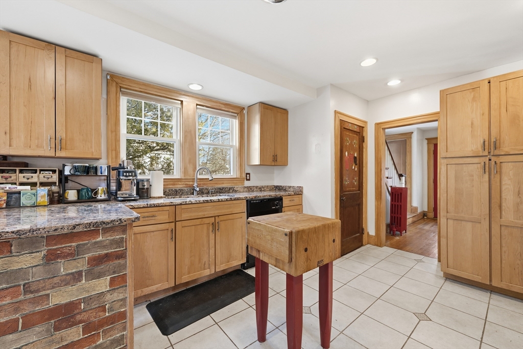 21 High Street Pepperell, MA 01463 - Photo 18 of 40 a kitchen with stainless steel appliances granite countertop a refrigerator and a stove top oven