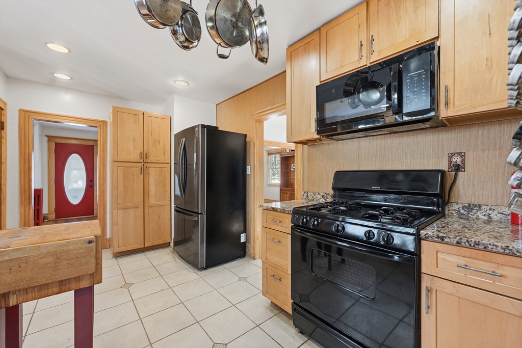 21 High Street Pepperell, MA 01463 - Photo 20 of 40 a kitchen with stainless steel appliances granite countertop a stove microwave and refrigerator