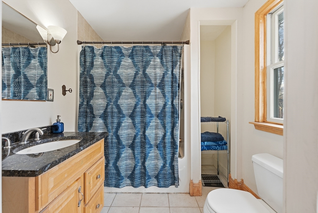 21 High Street Pepperell, MA 01463 - Photo 23 of 40 a bathroom with a granite countertop sink toilet and shower