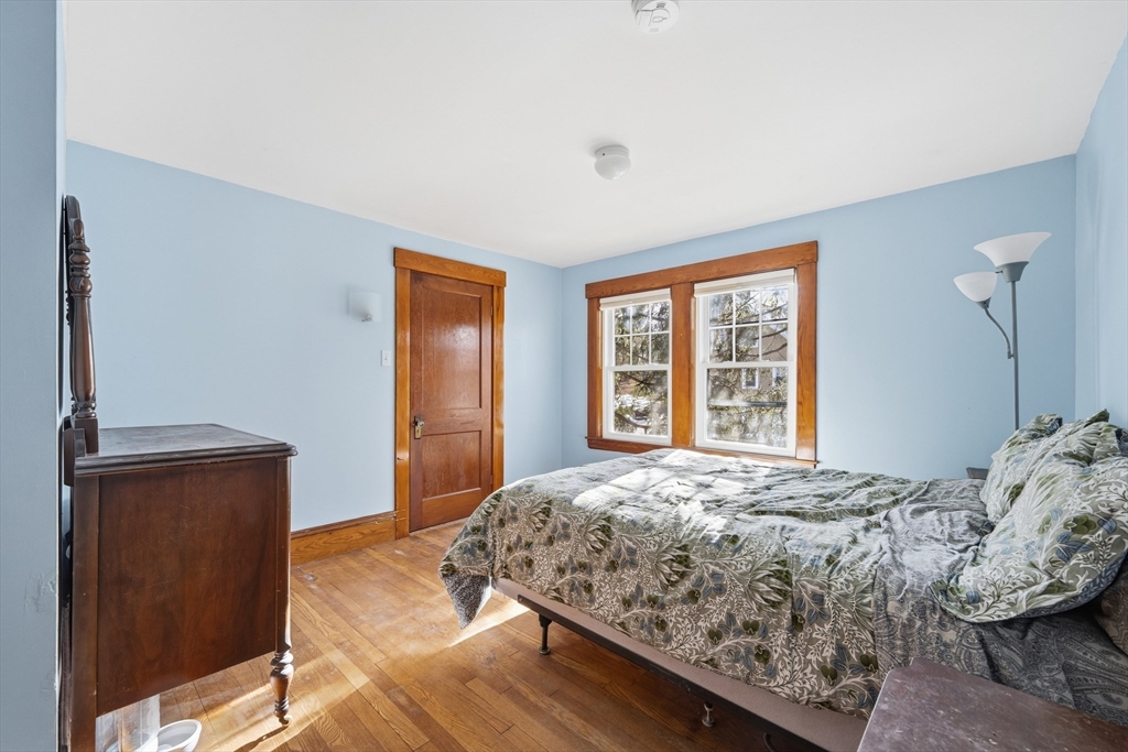 21 High Street Pepperell, MA 01463 - Photo 27 of 40 a bedroom with a bed and wooden floor