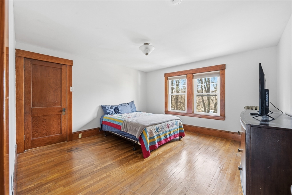 21 High Street Pepperell, MA 01463 - Photo 30 of 40 a bedroom with a bed and a flat screen tv