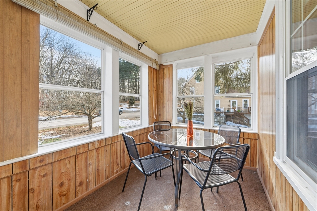 21 High Street Pepperell, MA 01463 - Photo 5 of 40 a dining room with furniture large windows and a chandelier