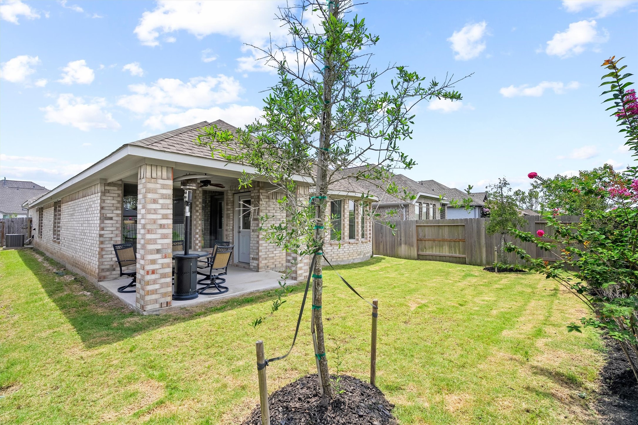 17270 Wild Watermelon Way Conroe, TX 77302 - Photo 24 of 28 The backyard features a covered patio, and a young shade tree. Fully fenced and ready for weekend gatherings, pets, or just some quiet time outside.