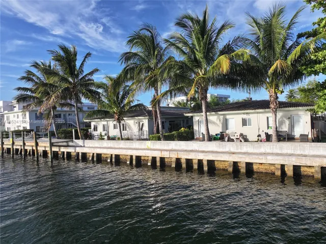 a view of a swimming pool with a table and chairs
