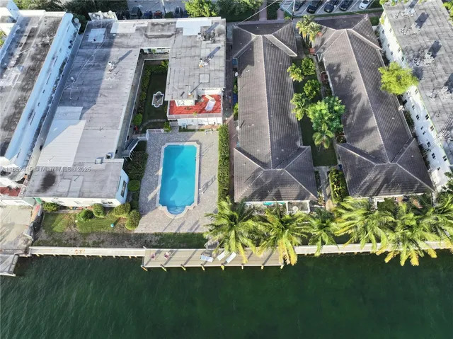 an aerial view of a house with a yard basket ball court and outdoor seating