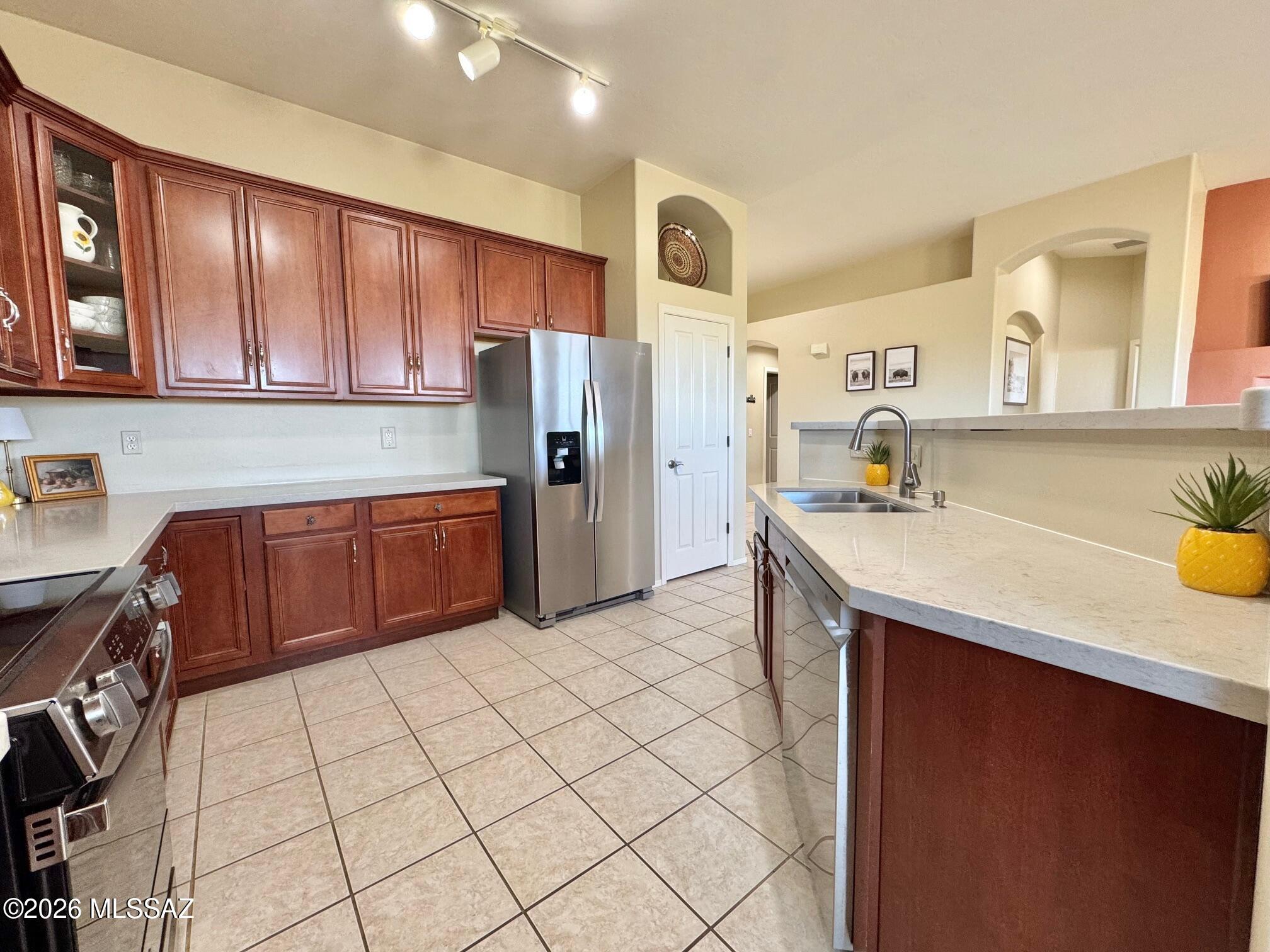 10835 South Heart Break Ridge Place Vail, AZ 85641 - Photo 15 of 49 a kitchen with stainless steel appliances a sink cabinets and wooden floor