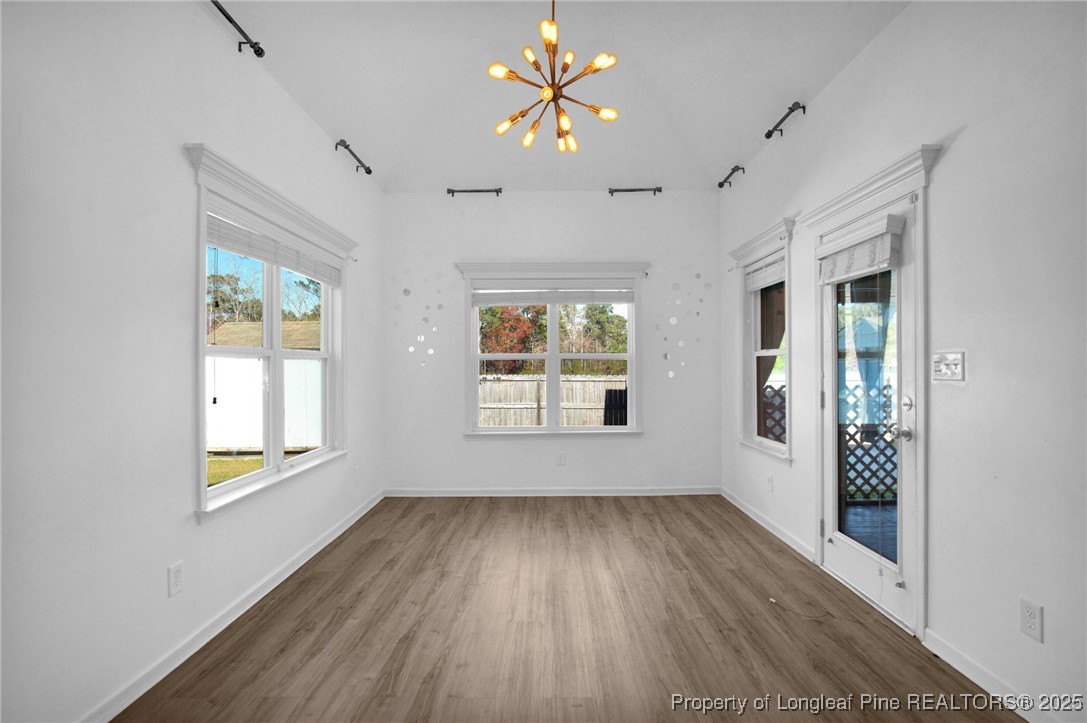 2145 Harrington Road Fayetteville, NC 28306 - Photo 22 of 50 a view of an empty room with a window and wooden floor